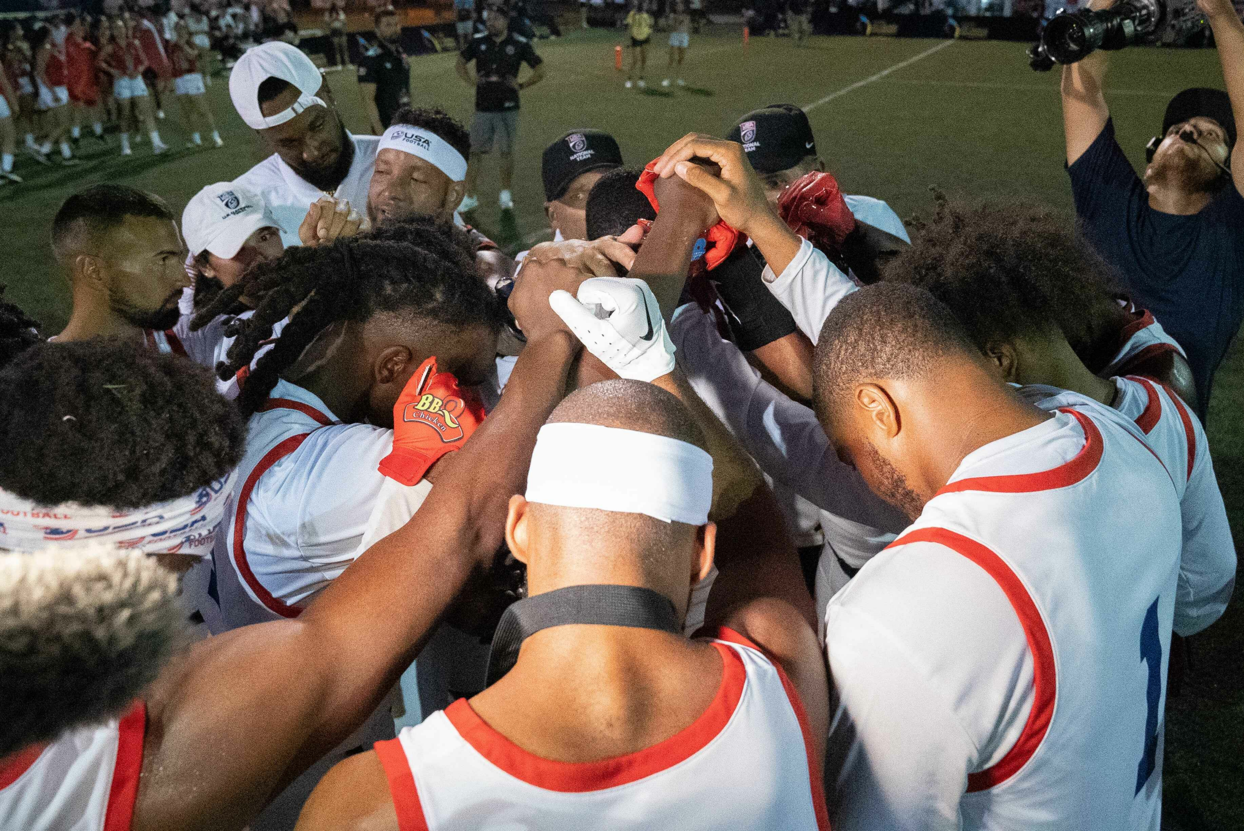 Bruce Mapp (No. 1) and the U.S. Men's Flag National Team huddle before a game.